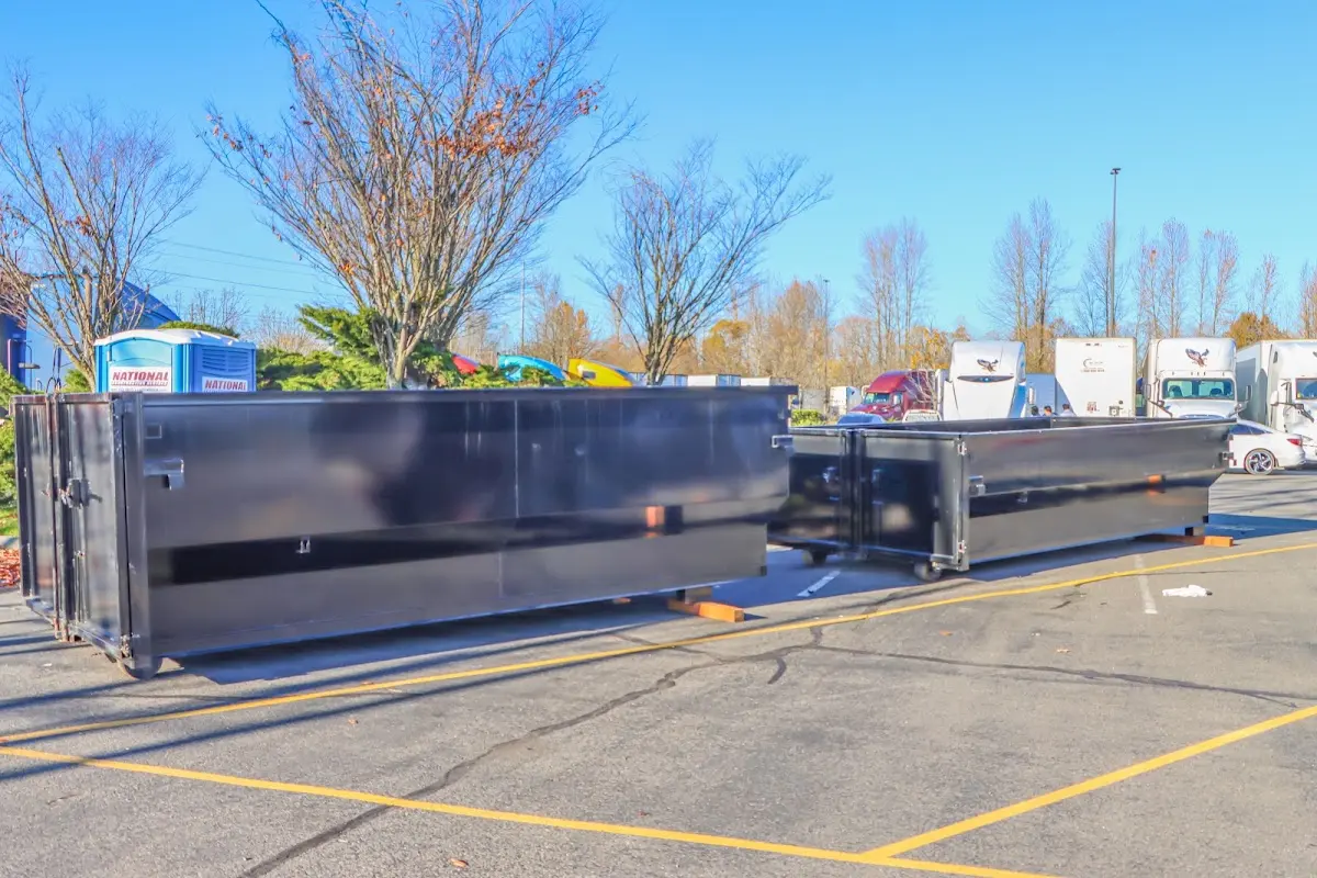 Professional dumpster rental service with roll-off container on residential driveway in Spring Creek